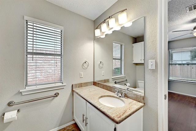 1807 Hollow Tree Blvd, Round Rock, TX 78681 - bathroom with a textured ceiling, vanity, a ceiling fan, and wood finished floors