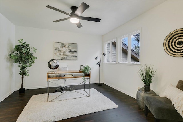 office space with a ceiling fan, baseboards, and wood finished floors