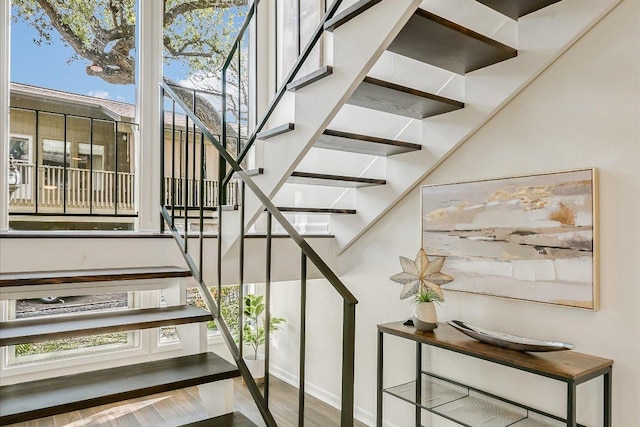 stairs featuring wood finished floors