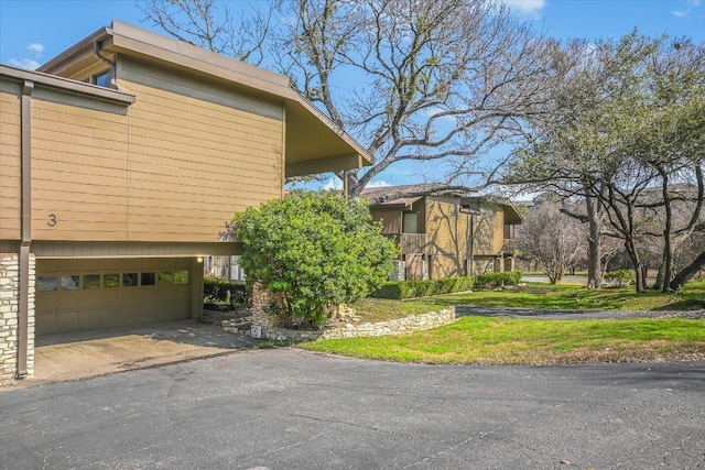 view of home's exterior with a garage and driveway