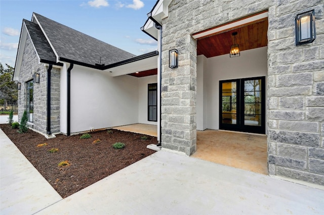 360 Judy Dr, Dripping Springs, TX 78620 - doorway to property featuring stone siding, a shingled roof, stucco siding, and french doors