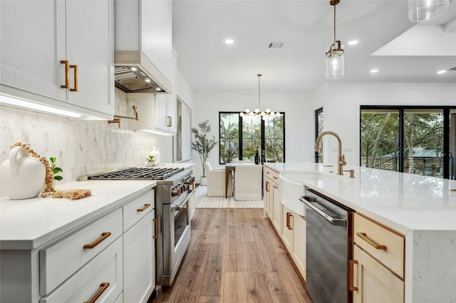 360 Judy Dr, Dripping Springs, TX 78620 - kitchen with a sink, appliances with stainless steel finishes, light wood-style floors, decorative backsplash, and recessed lighting