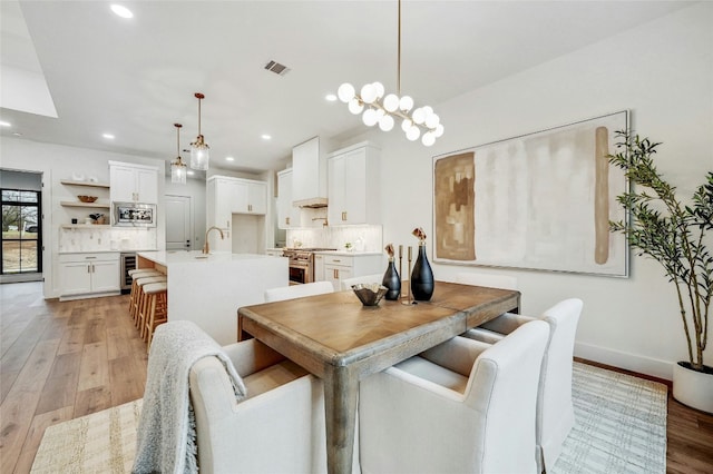 360 Judy Dr, Dripping Springs, TX 78620 - dining room featuring wine cooler, visible vents, recessed lighting, baseboards, and light wood-style floors