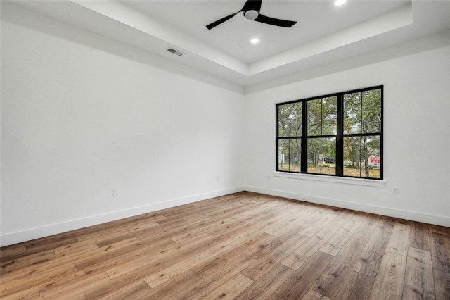 360 Judy Dr, Dripping Springs, TX 78620 - spare room featuring light wood-style flooring, visible vents, baseboards, a raised ceiling, and ceiling fan