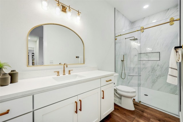 360 Judy Dr, Dripping Springs, TX 78620 - full bath with recessed lighting, toilet, vanity, wood finished floors, and a marble finish shower