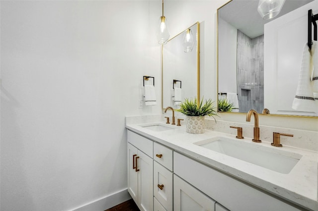 360 Judy Dr, Dripping Springs, TX 78620 - full bath featuring double vanity, baseboards, a tile shower, and a sink