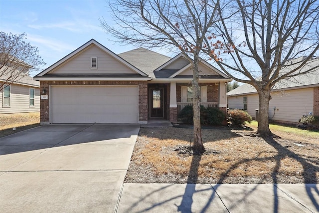 craftsman-style house featuring a garage, concrete driveway, brick siding, and a porch