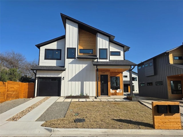 contemporary home with board and batten siding, roof with shingles, fence, and an attached garage