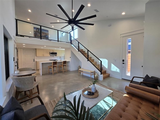 5305 Grover Ave Unit 2, Austin, TX 78756 - living room with recessed lighting, finished concrete floors, stairway, ceiling fan, and a towering ceiling