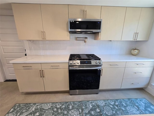 5305 Grover Ave Unit 2, Austin, TX 78756 - kitchen with stainless steel appliances, tasteful backsplash, light stone counters, and modern cabinets