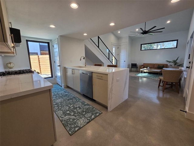 5305 Grover Ave Unit 2, Austin, TX 78756 - kitchen with dishwasher, concrete flooring, recessed lighting, light stone counters, and a peninsula