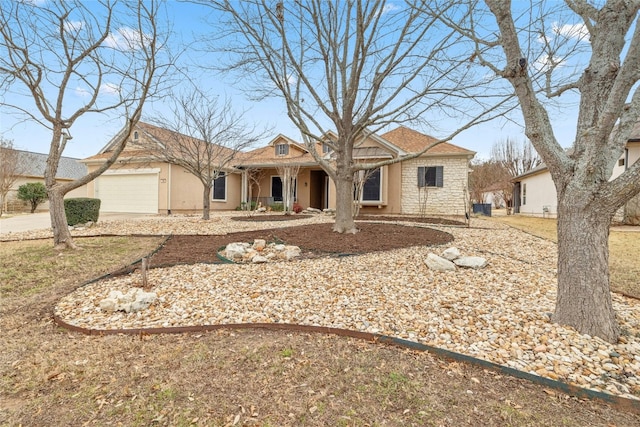 view of front of home featuring stone siding, an attached garage, and stucco siding