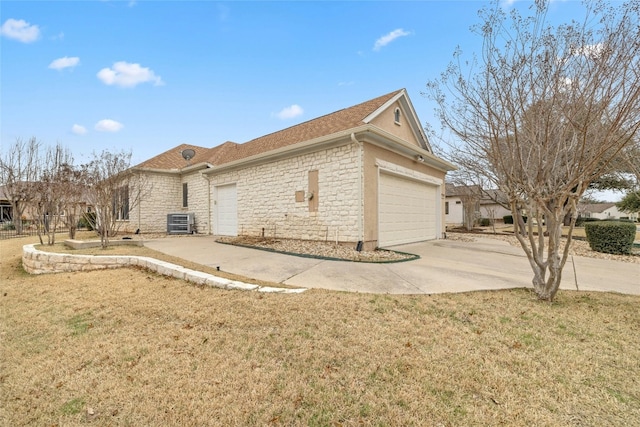 view of home's exterior with an attached garage, cooling unit, brick siding, a yard, and concrete driveway