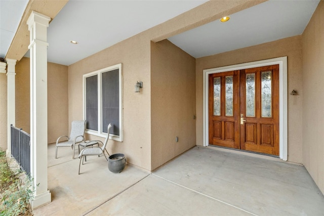 property entrance with stucco siding