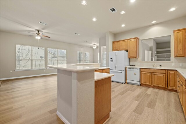 122 Durango Trl, Georgetown, TX 78633 - kitchen featuring white appliances, a ceiling fan, a center island, light wood-style floors, and recessed lighting