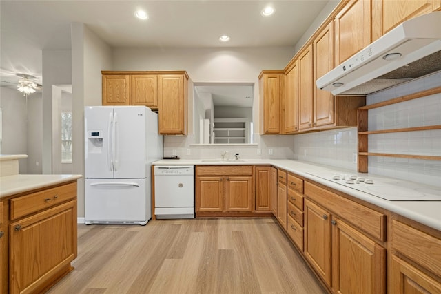 122 Durango Trl, Georgetown, TX 78633 - kitchen with white appliances, under cabinet range hood, a sink, light wood finished floors, and recessed lighting