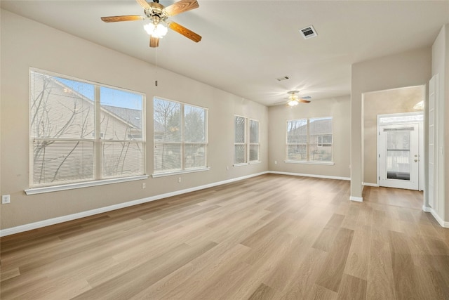 122 Durango Trl, Georgetown, TX 78633 - unfurnished living room featuring a ceiling fan, baseboards, and light wood-type flooring