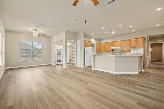 unfurnished living room featuring a ceiling fan and visible vents