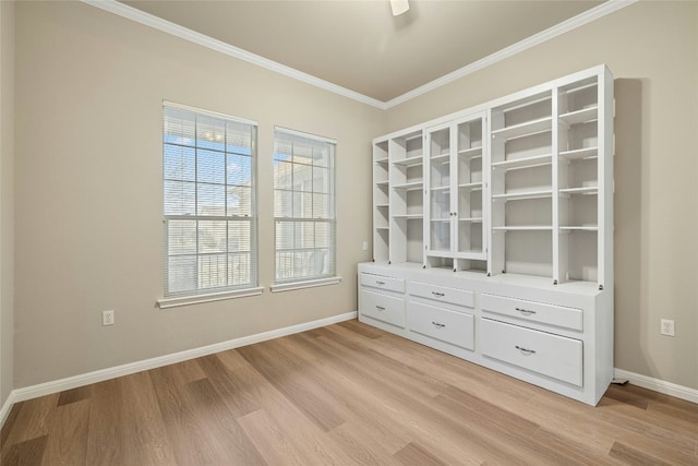 interior space featuring light wood-style flooring, baseboards, and crown molding