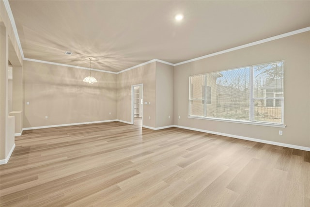 unfurnished living room featuring ornamental molding, light wood-style flooring, and baseboards