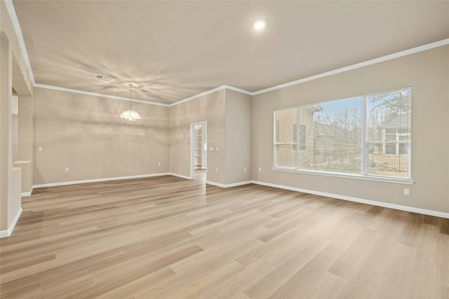 122 Durango Trl, Georgetown, TX 78633 - unfurnished room with a chandelier, baseboards, light wood finished floors, and ornamental molding
