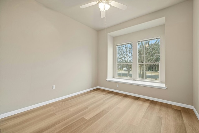 unfurnished room featuring ceiling fan, light wood-style flooring, and baseboards