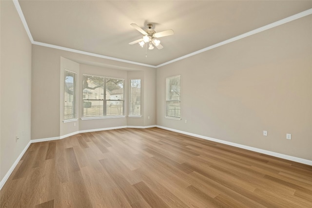 empty room featuring light wood-style floors, baseboards, a ceiling fan, and ornamental molding