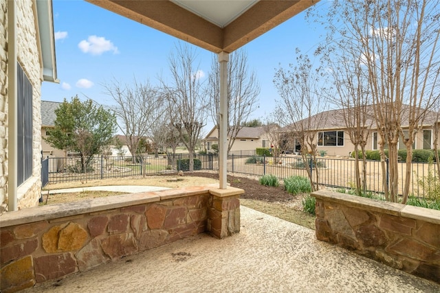 view of patio / terrace featuring a fenced backyard and a residential view