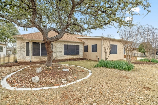 122 Durango Trl, Georgetown, TX 78633 - back of house with stone siding, stucco siding, and roof with shingles