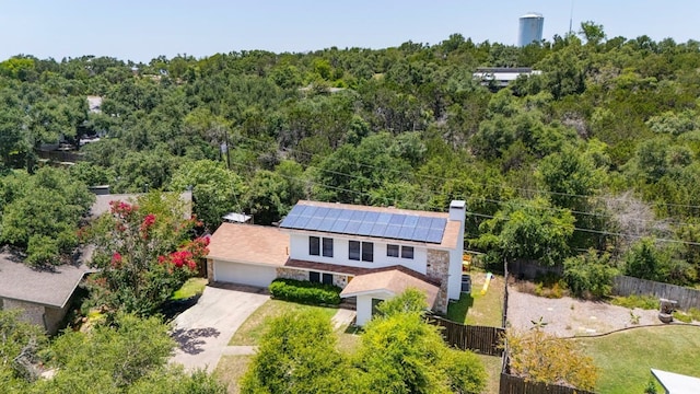 birds eye view of property featuring a view of trees