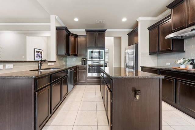 430 Archstone Loop, Belton, TX 76513 - kitchen featuring a sink, appliances with stainless steel finishes, dark stone countertops, a kitchen island, and dark brown cabinets