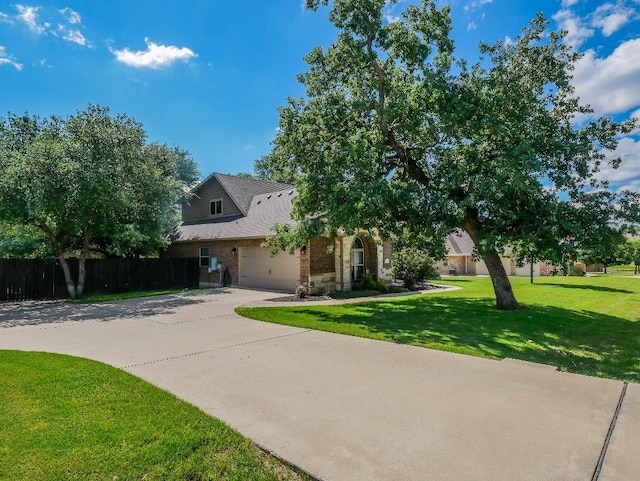 430 Archstone Loop, Belton, TX 76513 - view of property hidden behind natural elements featuring an attached garage, concrete driveway, and stone siding