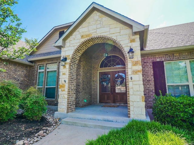 430 Archstone Loop, Belton, TX 76513 - property entrance with brick siding, stone siding, roof with shingles, and french doors