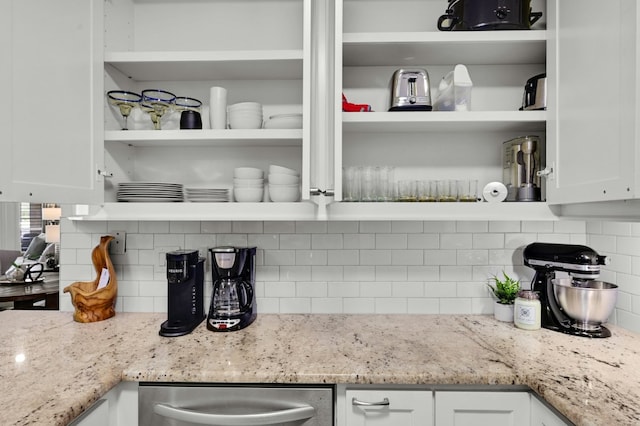 kitchen with light stone countertops, tasteful backsplash, white cabinetry, and open shelves