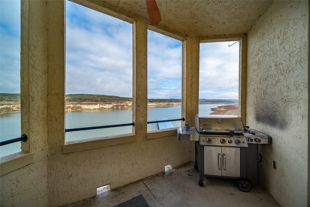 unfurnished sunroom with a water view