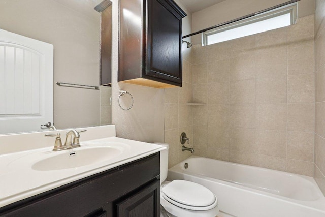 bathroom featuring tub / shower combination, vanity, and toilet