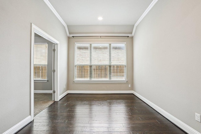 spare room with baseboards, ornamental molding, and hardwood / wood-style floors