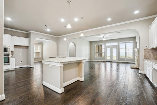 kitchen featuring baseboards, visible vents, decorative backsplash, appliances with stainless steel finishes, and dark wood-style flooring