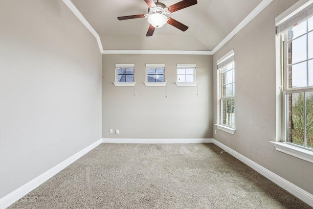 carpeted spare room with crown molding, baseboards, and ceiling fan