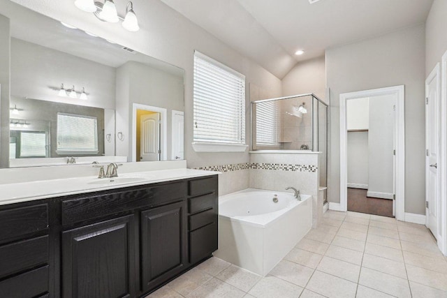 bathroom with a garden tub, a stall shower, tile patterned flooring, and a healthy amount of sunlight