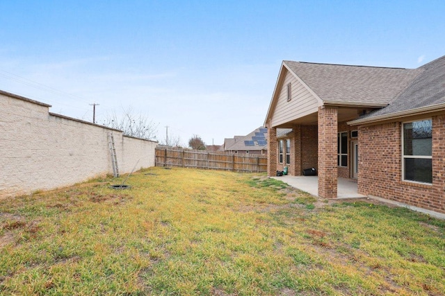 view of yard with a patio area and a fenced backyard