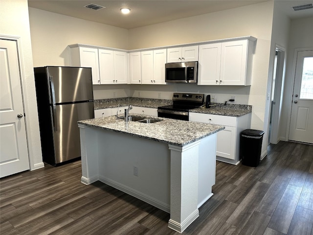 kitchen with visible vents, appliances with stainless steel finishes, dark wood-type flooring, and a sink