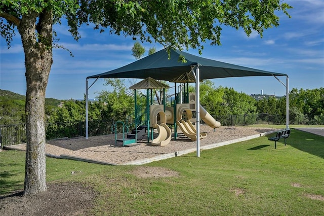 community playground with fence and a lawn