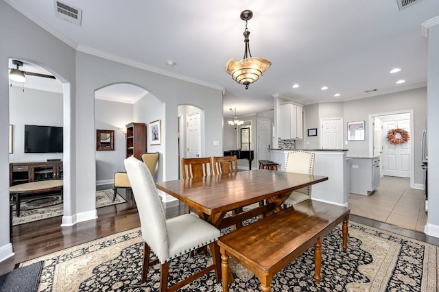 dining room with baseboards, crown molding, visible vents, and recessed lighting