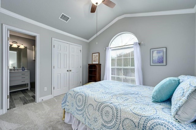 bedroom with lofted ceiling, ensuite bathroom, carpet floors, visible vents, and ornamental molding