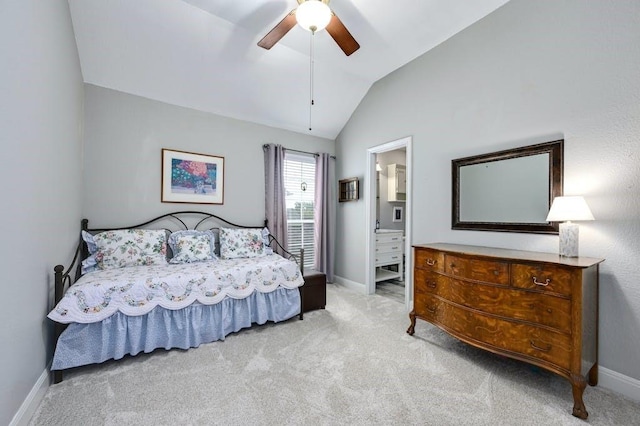 carpeted bedroom featuring ensuite bath, baseboards, vaulted ceiling, and a ceiling fan