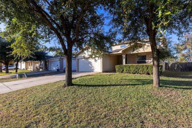 view of front of house featuring a garage, driveway, a front lawn, and fence