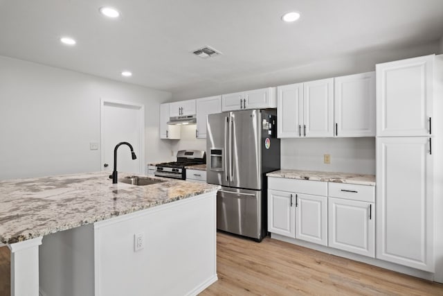 10001 Woodglen Dr, Austin, TX 78753 - kitchen featuring appliances with stainless steel finishes, a sink, under cabinet range hood, recessed lighting, and white cabinetry