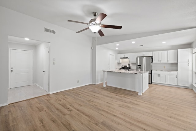 10001 Woodglen Dr, Austin, TX 78753 - kitchen featuring light wood-style flooring, appliances with stainless steel finishes, a ceiling fan, white cabinetry, and recessed lighting