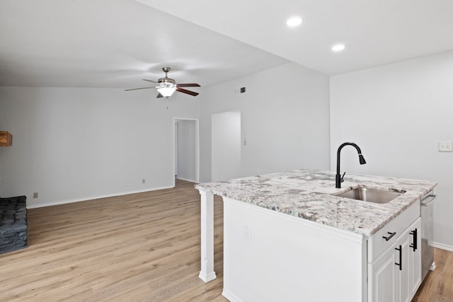 10001 Woodglen Dr, Austin, TX 78753 - kitchen with a sink, light wood-type flooring, a ceiling fan, light stone countertops, and open floor plan